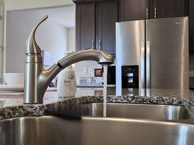 3371 Yellowtop Loop, Clermont, FL 34714 - kitchen view of stainless steel refrigerator with ice dispenser, a sink, and dark brown cabinetry