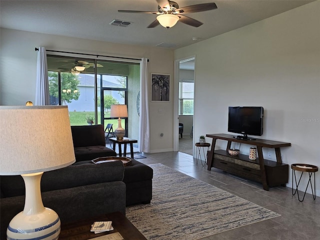 3371 Yellowtop Loop, Clermont, FL 34714 - tiled living room featuring a ceiling fan and baseboards