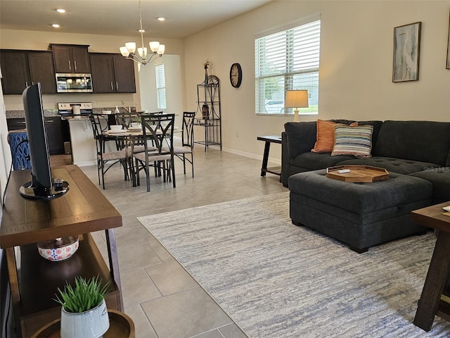 3371 Yellowtop Loop, Clermont, FL 34714 - living room featuring healthy amount of natural light, a chandelier, recessed lighting, baseboards, and light tile patterned flooring