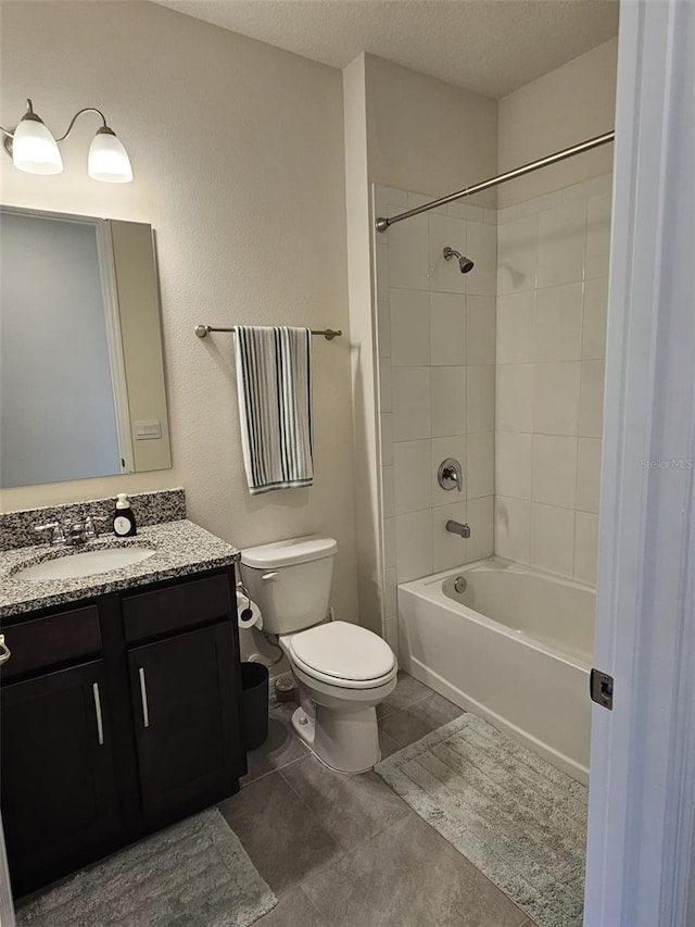 3371 Yellowtop Loop, Clermont, FL 34714 - full bath with toilet, vanity,  shower combination, a textured ceiling, and tile patterned flooring