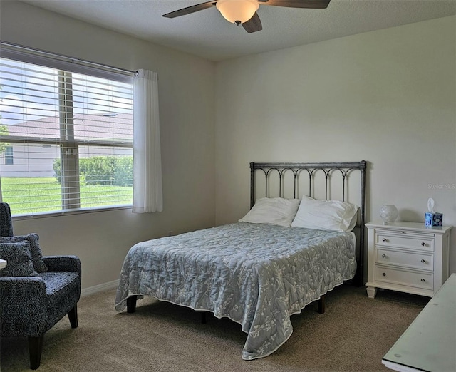 3371 Yellowtop Loop, Clermont, FL 34714 - bedroom with dark colored carpet, a ceiling fan, and baseboards