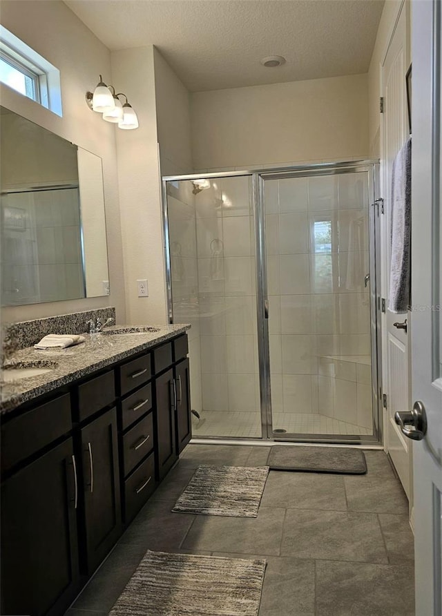 3371 Yellowtop Loop, Clermont, FL 34714 - full bathroom with a shower stall, double vanity, and a textured ceiling