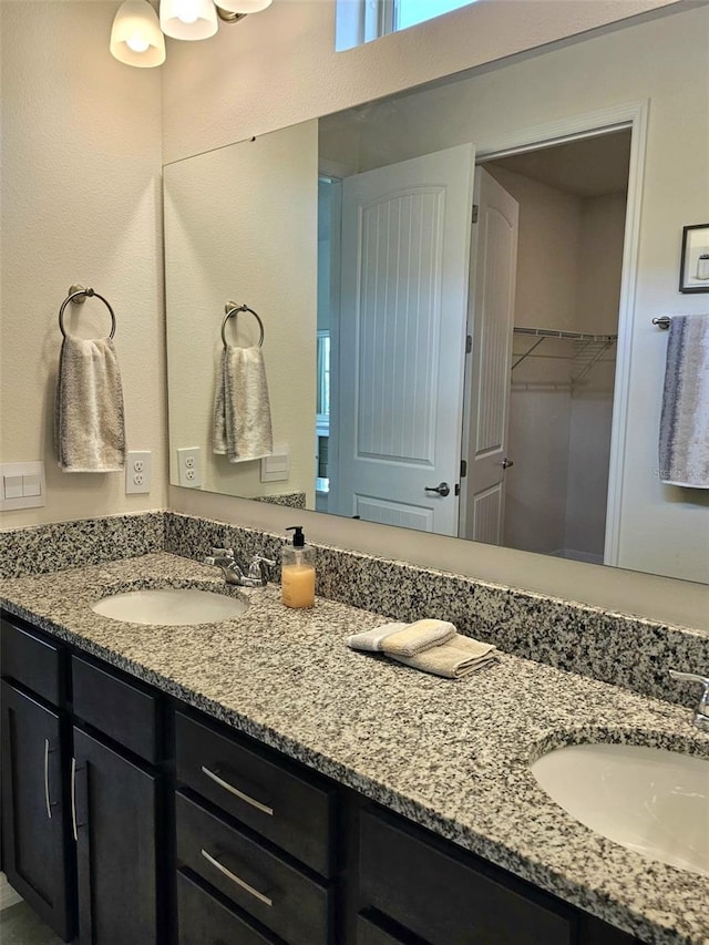 3371 Yellowtop Loop, Clermont, FL 34714 - full bathroom featuring double vanity and a walk in closet