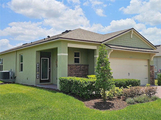 3371 Yellowtop Loop, Clermont, FL 34714 - view of front of property featuring a front lawn, an attached garage, stucco siding, and stone siding