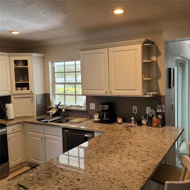 8539 Clematis Ln, Orlando, FL 32819 - kitchen with a sink, ornamental molding, dishwashing machine, white cabinets, and tasteful backsplash
