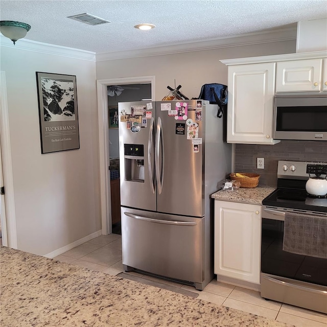 8539 Clematis Ln, Orlando, FL 32819 - kitchen featuring stainless steel appliances, light tile patterned flooring, ornamental molding, white cabinetry, and backsplash