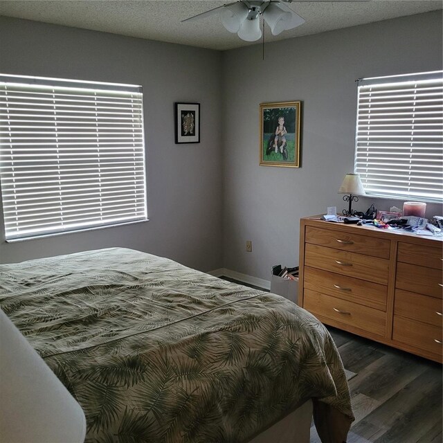 8539 Clematis Ln, Orlando, FL 32819 - bedroom with dark wood-type flooring and a ceiling fan