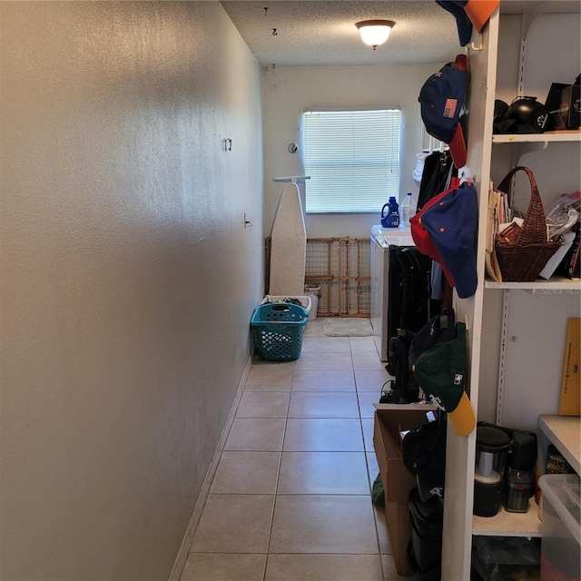 8539 Clematis Ln, Orlando, FL 32819 - laundry room with washing machine and clothes dryer, tile patterned floors, and baseboards