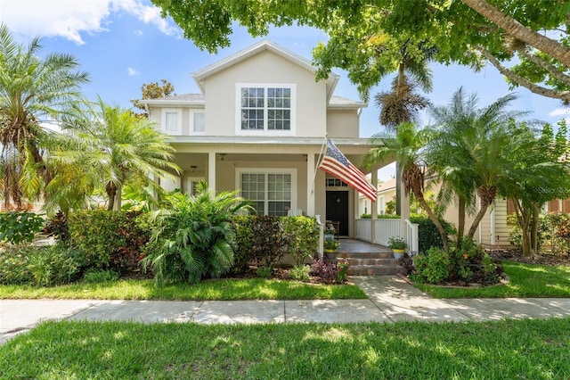 7003 Cupseed Ln, Harmony, FL 34773 - view of front of home with covered porch and stucco siding