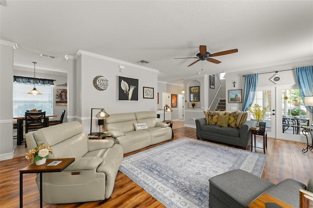 7003 Cupseed Ln, Harmony, FL 34773 - living area with stairway, ceiling fan, ornamental molding, wood finished floors, and baseboards