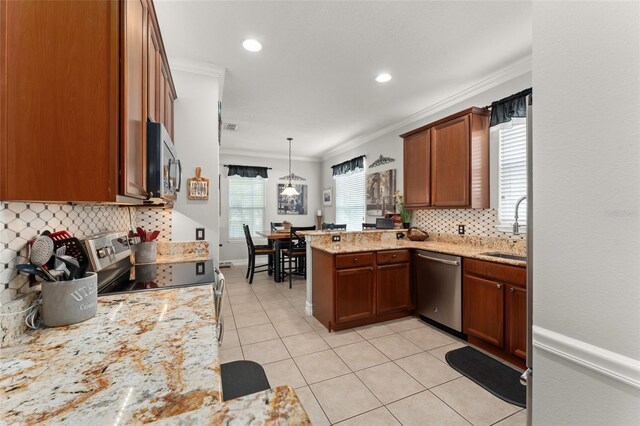 7003 Cupseed Ln, Harmony, FL 34773 - kitchen featuring stainless steel appliances, a peninsula, tasteful backsplash, light tile patterned floors, and a sink