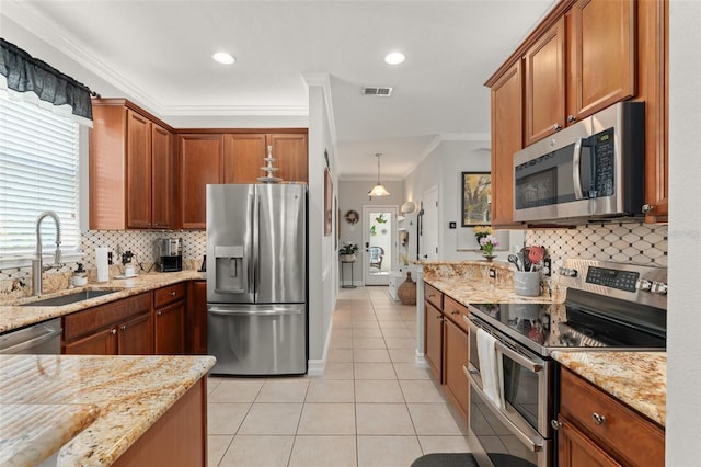 7003 Cupseed Ln, Harmony, FL 34773 - kitchen featuring appliances with stainless steel finishes, a sink, light tile patterned floors, crown molding, and backsplash