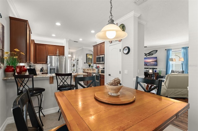7003 Cupseed Ln, Harmony, FL 34773 - dining room with crown molding, recessed lighting, baseboards, and light tile patterned floors