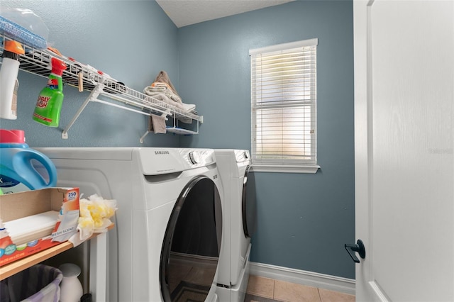7003 Cupseed Ln, Harmony, FL 34773 - laundry area featuring separate washer and dryer, tile patterned floors, baseboards, and plenty of natural light