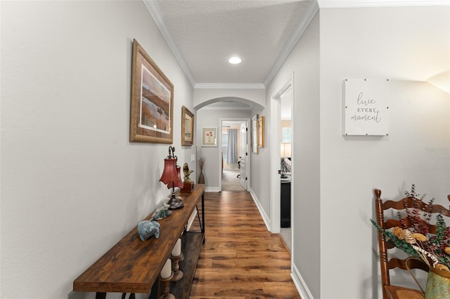 7003 Cupseed Ln, Harmony, FL 34773 - hall featuring arched walkways, wood finished floors, crown molding, and baseboards