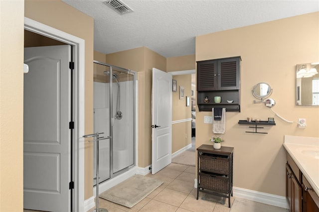 7003 Cupseed Ln, Harmony, FL 34773 - full bath with vanity, a stall shower, baseboards, tile patterned flooring, and a textured ceiling
