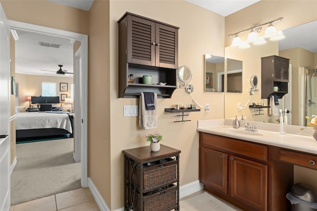 7003 Cupseed Ln, Harmony, FL 34773 - ensuite bathroom featuring vanity, a ceiling fan, tile patterned flooring, and baseboards