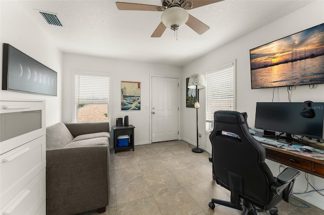 7003 Cupseed Ln, Harmony, FL 34773 - home office with a ceiling fan, light tile patterned floors, and baseboards