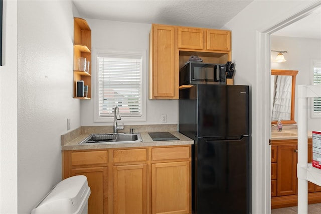 7003 Cupseed Ln, Harmony, FL 34773 - kitchen featuring black appliances, a sink, light countertops, and open shelves