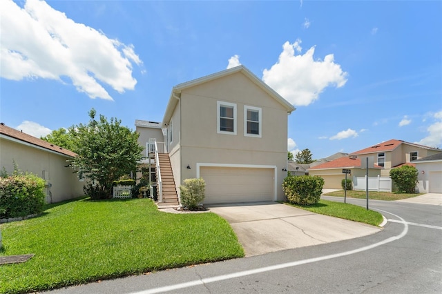 7003 Cupseed Ln, Harmony, FL 34773 - traditional home with a garage, stucco siding, stairs, driveway, and a front yard
