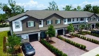 391 Cape Honeysuckle Pl, Sanford, FL 32771 - townhome / multi-family property with driveway and a garage