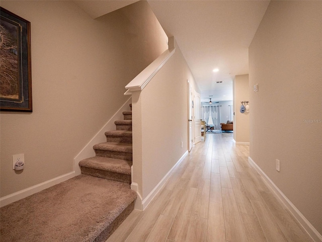 391 Cape Honeysuckle Pl, Sanford, FL 32771 - corridor featuring stairway, light wood-type flooring, and baseboards