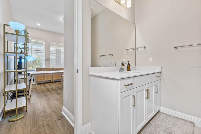 16013 Silver Brook Way, Winter Garden, FL 34787 - bathroom featuring baseboards, wood finished floors, vanity, and recessed lighting