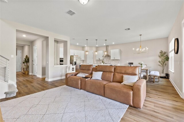 16013 Silver Brook Way, Winter Garden, FL 34787 - living room featuring light wood-style floors, baseboards, a chandelier, and recessed lighting