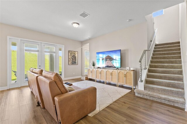 16013 Silver Brook Way, Winter Garden, FL 34787 - living area featuring french doors, wood finished floors, and stairway