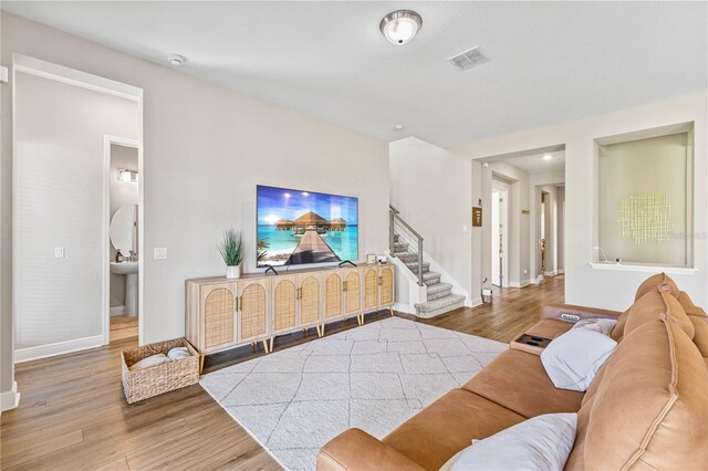 16013 Silver Brook Way, Winter Garden, FL 34787 - living room with wood finished floors, baseboards, and stairs