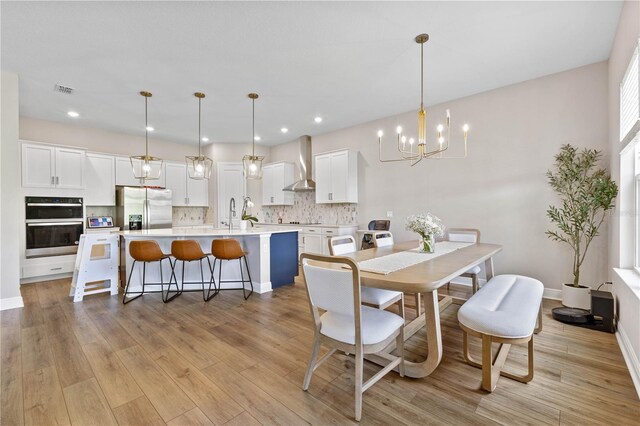 16013 Silver Brook Way, Winter Garden, FL 34787 - dining area with a chandelier, light wood-style flooring, recessed lighting, and baseboards