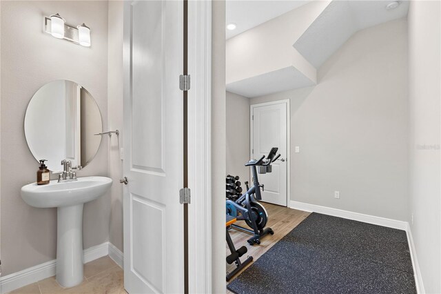 16013 Silver Brook Way, Winter Garden, FL 34787 - bathroom featuring baseboards, wood finished floors, and a sink