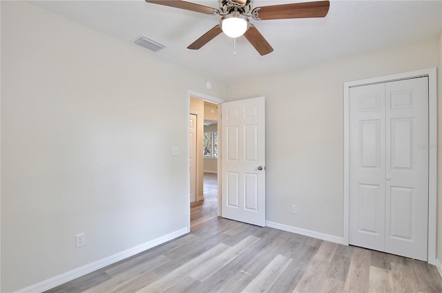 222 E Atwater Ave, Eustis, FL 32726 - unfurnished bedroom with light wood-type flooring, baseboards, a ceiling fan, and a closet