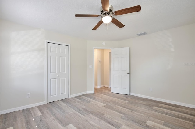 222 E Atwater Ave, Eustis, FL 32726 - unfurnished bedroom featuring light wood finished floors, a closet, baseboards, and a ceiling fan