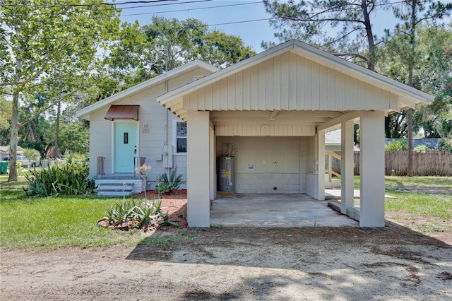 222 E Atwater Ave, Eustis, FL 32726 - bungalow-style home featuring electric water heater, a carport, and dirt driveway