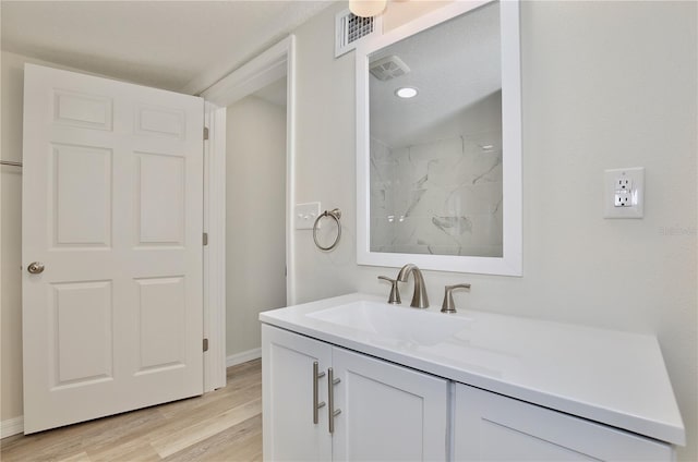 222 E Atwater Ave, Eustis, FL 32726 - full bath with vanity, wood finished floors, a shower, and baseboards