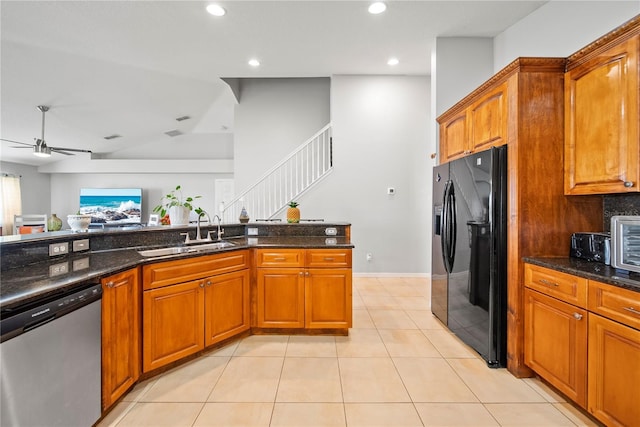 2332 Andrews Valley Dr, Kissimmee, FL 34758 - kitchen with dishwasher, black fridge, a sink, a ceiling fan, and dark stone counters
