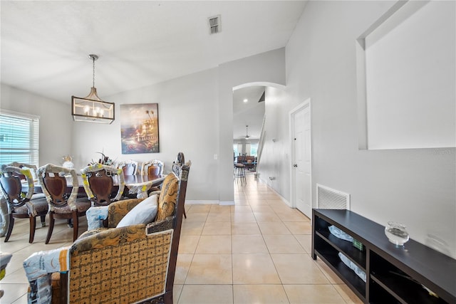 2332 Andrews Valley Dr, Kissimmee, FL 34758 - living room featuring a chandelier, arched walkways, light tile patterned floors, and baseboards
