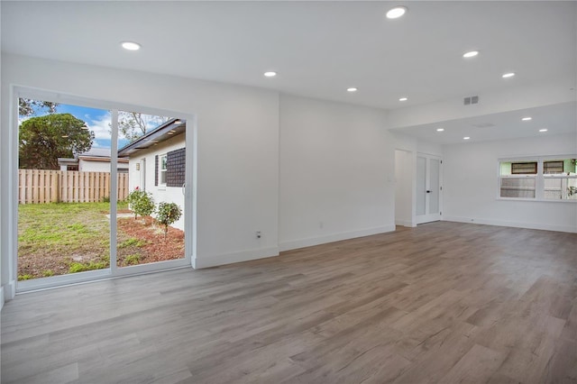 4201 Mizell St, Orlando, FL 32812 - unfurnished living room featuring recessed lighting, plenty of natural light, wood finished floors, and baseboards