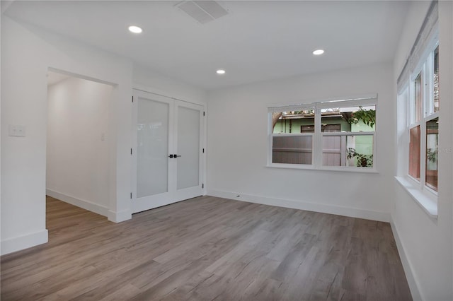 4201 Mizell St, Orlando, FL 32812 - unfurnished room with wood finished floors, french doors, baseboards, and recessed lighting