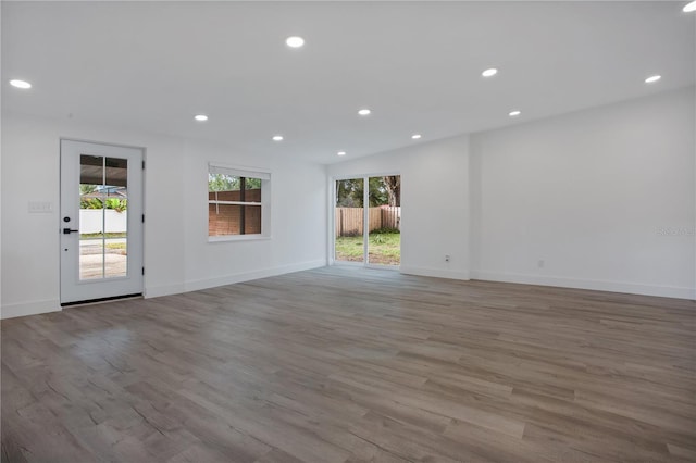 4201 Mizell St, Orlando, FL 32812 - empty room with wood finished floors, recessed lighting, and baseboards