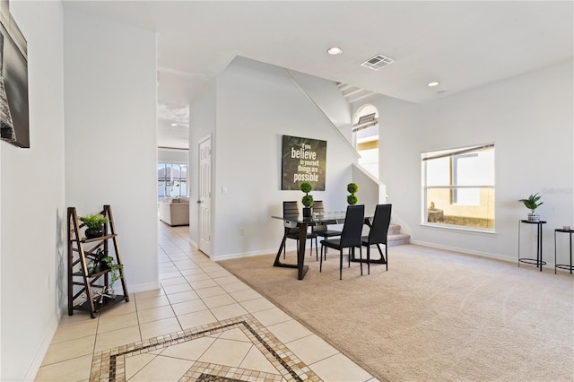 558 Cadiz Loop, Davenport, FL 33837 - dining room with light tile patterned flooring, light colored carpet, recessed lighting, and baseboards