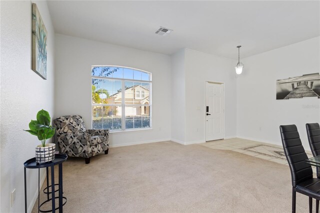 558 Cadiz Loop, Davenport, FL 33837 - living area featuring carpet flooring, baseboards, and tile patterned flooring