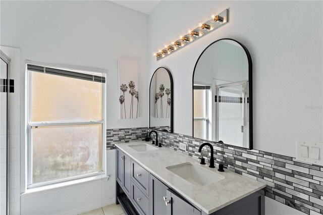 558 Cadiz Loop, Davenport, FL 33837 - full bath with double vanity, backsplash, and a shower with door