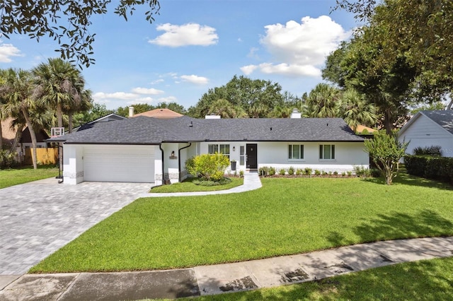 1327 Bridgeport Dr, Winter Park, FL 32789 - single story home with a garage, decorative driveway, a front lawn, stucco siding, and a chimney