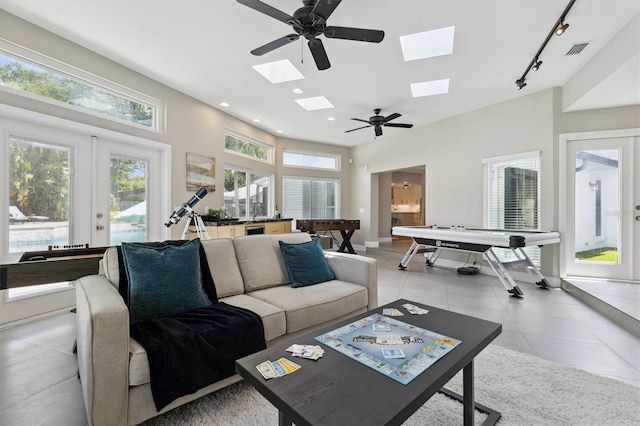 1327 Bridgeport Dr, Winter Park, FL 32789 - living room with track lighting, a skylight, light tile patterned flooring, recessed lighting, and a ceiling fan