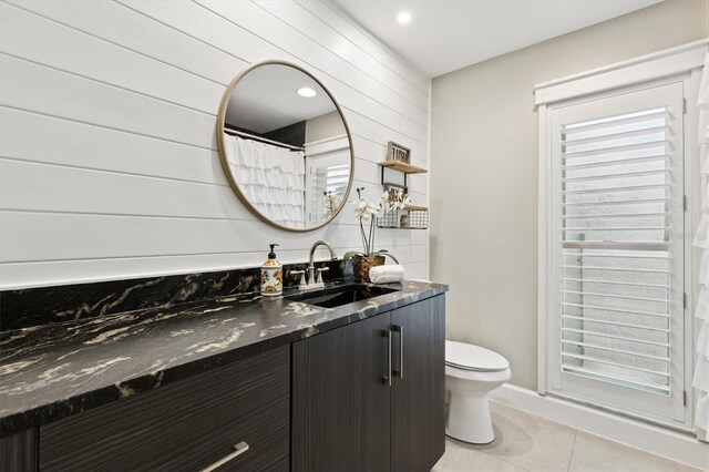 1327 Bridgeport Dr, Winter Park, FL 32789 - bathroom with vanity, tile patterned flooring, and wood walls
