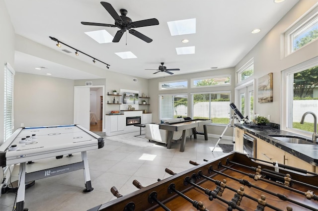 1327 Bridgeport Dr, Winter Park, FL 32789 - playroom featuring a skylight, light tile patterned floors, and recessed lighting