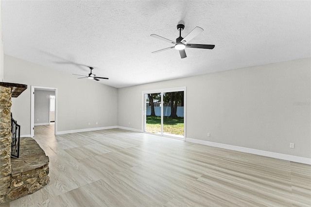 174 Pine Grove Ct, Daytona Beach, FL 32119 - unfurnished living room featuring a ceiling fan, a textured ceiling, and baseboards