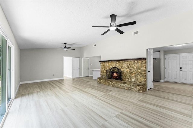 174 Pine Grove Ct, Daytona Beach, FL 32119 - unfurnished living room featuring a ceiling fan, a fireplace, baseboards, a textured ceiling, and lofted ceiling